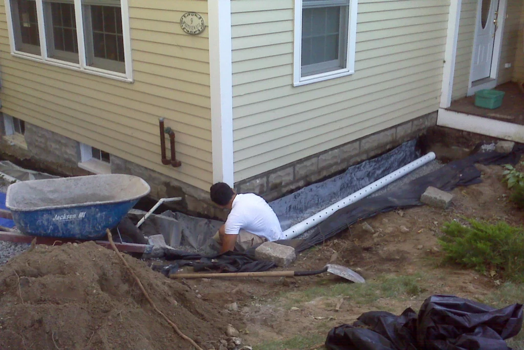 man-installing-home-french-drain | french-drain-installation-expert-near-me