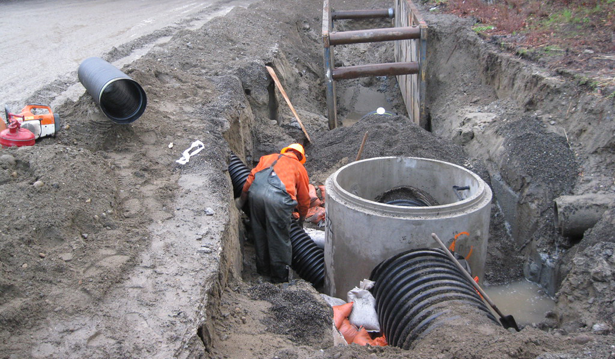 man working on an underground sewer line