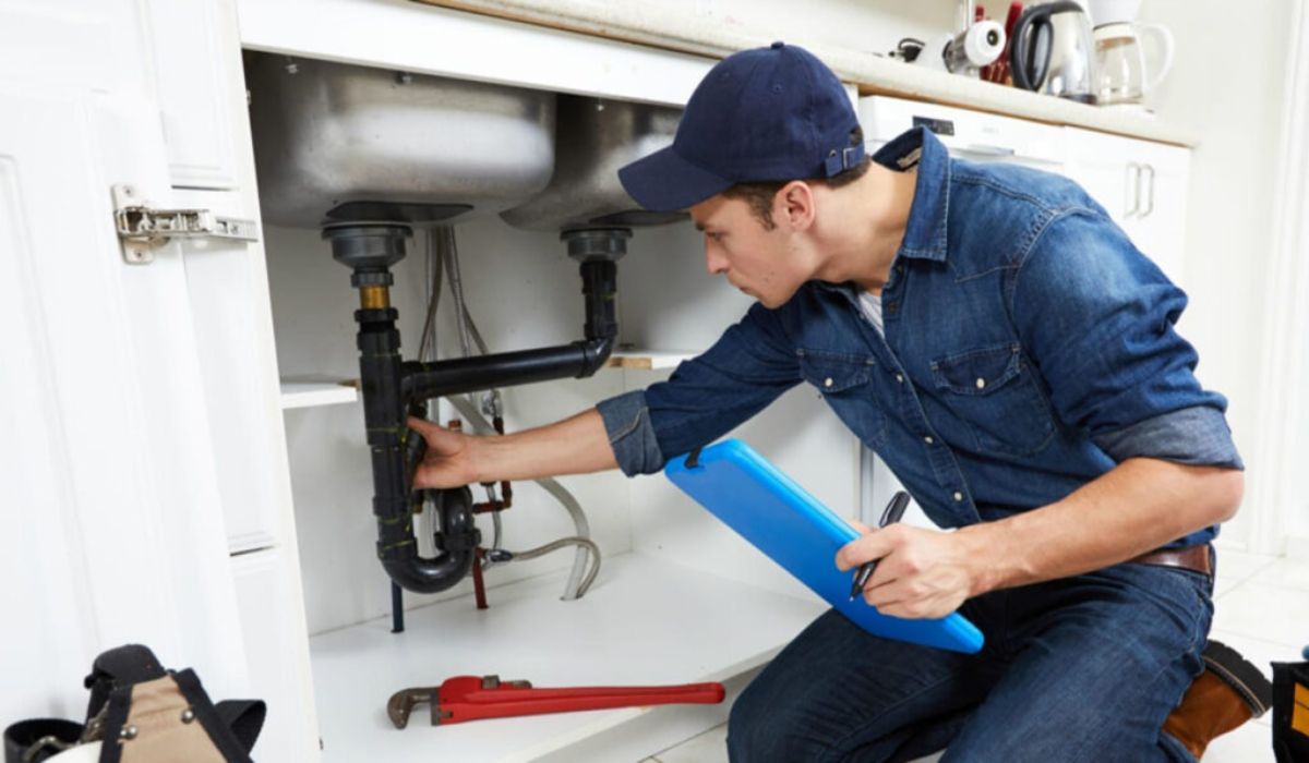 (plumbing and drainage service) a professional inspecting the sink pipes