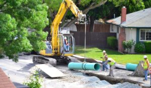 professional men repairing and cleaning a sewer