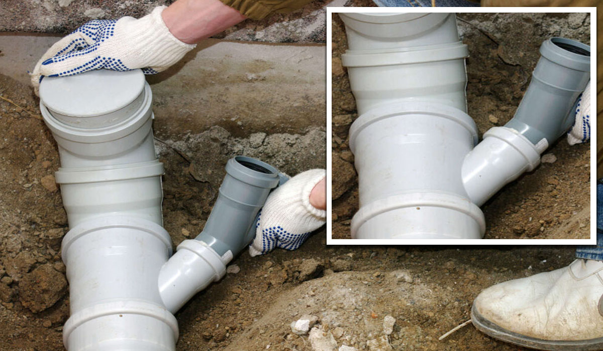 hands repairing drainage pipes