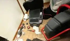 Sewer inspection tools and equipment, including a camera system, pipes, and repair supplies.