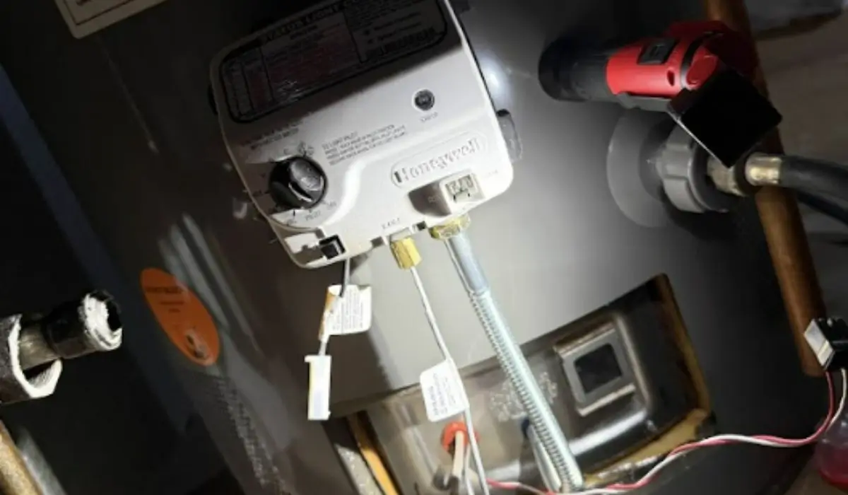 Close-up of a residential water heater control panel inspected during winter repair service in Naperville basement.