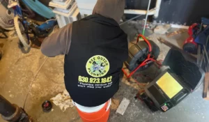 Bee Quick Plumbing technician working with equipment to address sewer gas smell in Naperville IL, offering professional plumbing services.